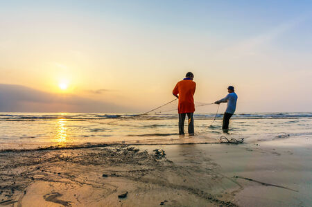 KUANTAN, MALAYSIA - JULY 20, 2014 - Fishermen do their work near Beserah beach, Kuantan, Malaysia at July 20, 2014. Fishermen are the main occupation for villagers at Kuantan village, Pahangのeditorial素材
