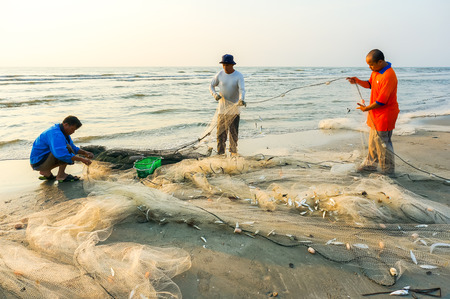 KUANTAN, MALAYSIA - JULY 20, 2014 - Fishermen do their work near Beserah beach, Kuantan, Malaysia at July 20, 2014. Fishermen are the main occupation for villagers at Kuantan village, Pahangのeditorial素材