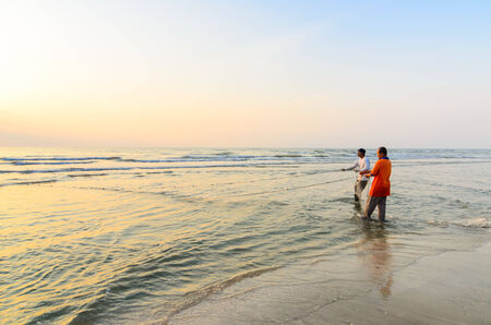 KUANTAN, MALAYSIA - JULY 20, 2014 - Fishermen do their work near Beserah beach, Kuantan, Malaysia at July 20, 2014. Fishermen are the main occupation for villagers at Kuantan village, Pahangのeditorial素材