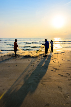 KUANTAN, MALAYSIA - JULY 20, 2014 - Fishermen do their work near Beserah beach, Kuantan, Malaysia at July 20, 2014. Fishermen are the main occupation for villagers at Kuantan village, Pahangのeditorial素材