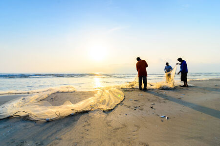 KUANTAN, MALAYSIA - JULY 20, 2014 - Fishermen do their work near Beserah beach, Kuantan, Malaysia at July 20, 2014. Fishermen are the main occupation for villagers at Kuantan village, Pahangのeditorial素材