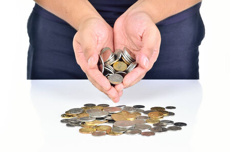 Man hand holding pile of coins on white background