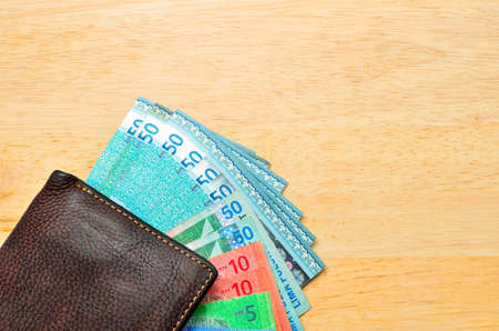 Money cash wallet on wooden table with copy spaceの写真素材