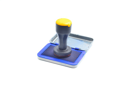 Rubber stamp with stamp pad in front of a white background