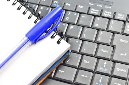 A notepad and keyboard of a computer. write down and saveの写真素材