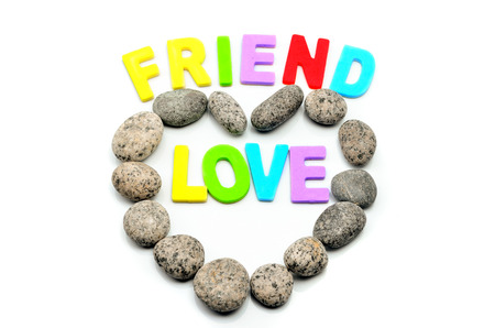 heart shape pebble stone with friend and love textの写真素材