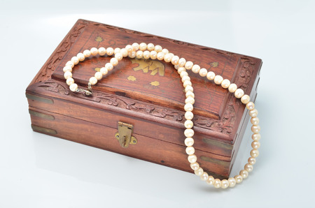 Small wooden chest with white pearl necklaceの写真素材
