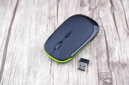 Wireless computer mouse on wooden background