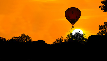 Silhouette of hot air balloon over sunset backgroundの写真素材