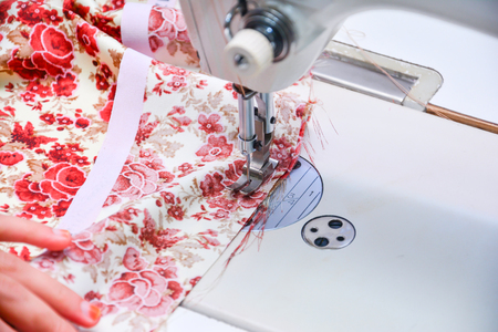 Seamstress working on sewing machineの写真素材
