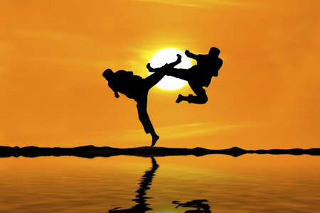 Fighting an enemy near the beach when the sun goes downの写真素材