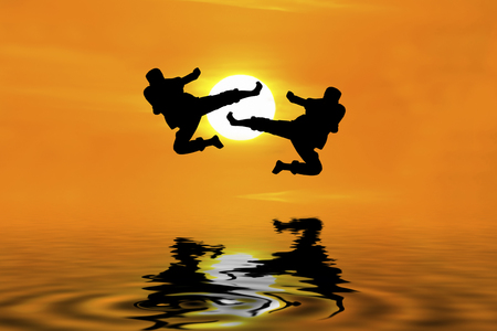 Fighting an enemy near the beach when the sun goes downの写真素材