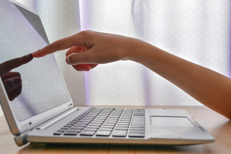 Business woman touching screen of laptopの写真素材