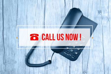 Hand Typing on keyboard with text CALL US NOWの写真素材