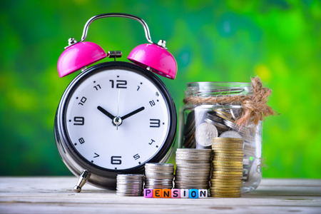 Alarm clock, Coins and cube dices with word pension