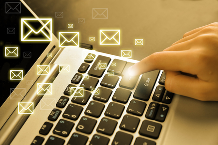Email concept with laptop and handsの写真素材