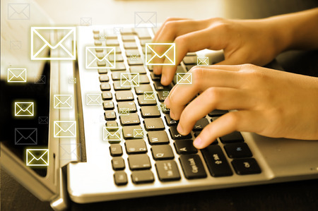 Email concept with laptop and handsの写真素材