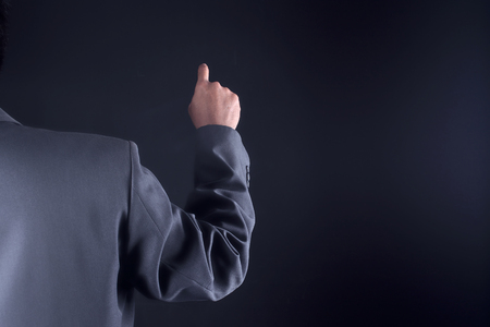 Business man with pointing to something or touching a touch screenの写真素材