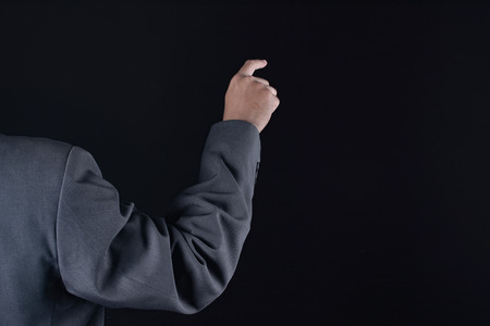 Business man with pointing to something or touching a touch screenの写真素材