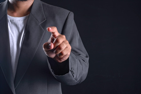 Business man with pointing to something or touching a touch screenの写真素材