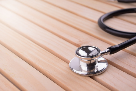 Stethoscope on wooden background, closeupの写真素材