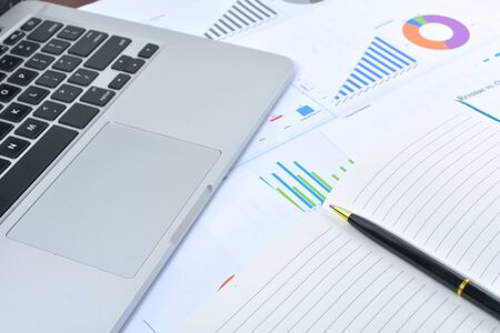 Business and Finances Concepts. Laptop, Notebook with graph and pen