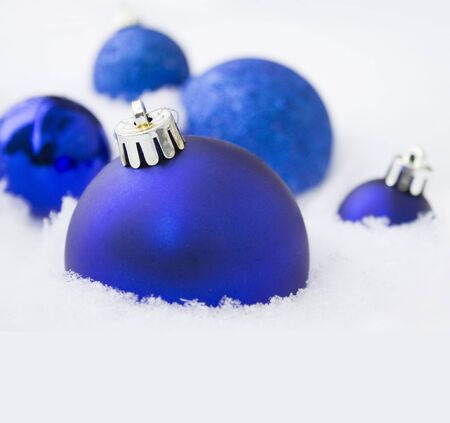 Christmas blue decorations on snow background.の写真素材
