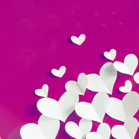 Valentine's Day vintage background, white paper hearts on red background.の写真素材
