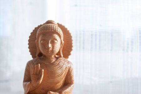 Wooden Buddha with white backgroundの写真素材