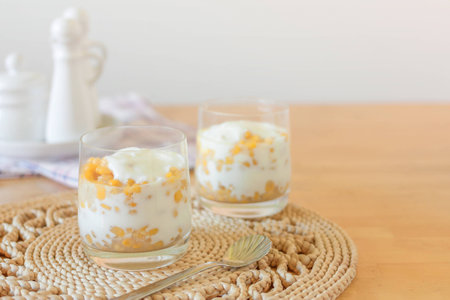 Buttered sweet corn with soft cheese serve in a glass with soft light backgroundの写真素材
