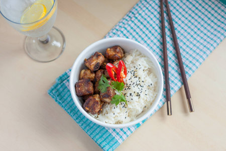 Horizontal soft focus garlic pepper pork ribs with rice Asian style and fizzy drinkの写真素材
