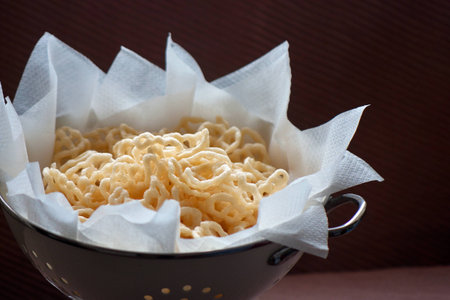 Vegetarian leaf shaped fryums Asian snack in food containerの写真素材