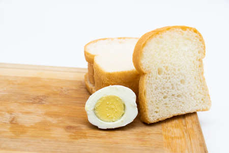 Bread sliced and boiled egg isolated on white backgroundの写真素材