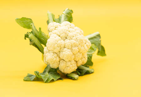Cauliflower isolated on yellow background with clipping pathの写真素材