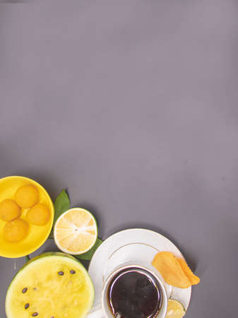 cup of tea with fruits and biscuit isolate on black background, top viewの写真素材