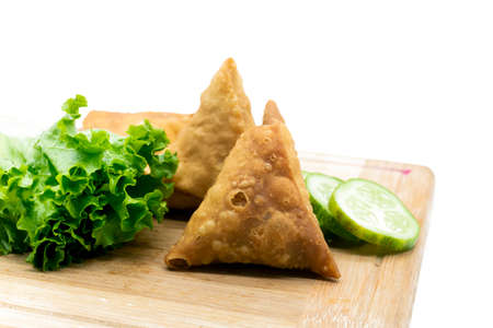 three pieces golden samosa and singara isolated on white backgroundの写真素材