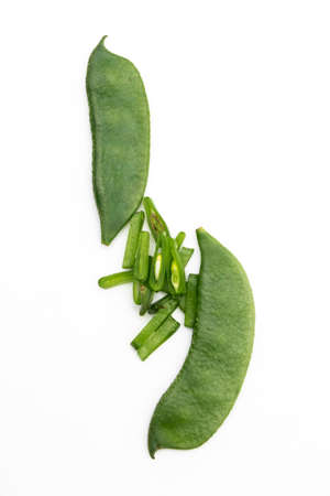 green Lima beans or Hyacinth beans slices over on white background, top view