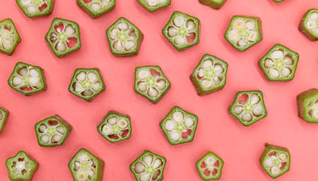fresh okra pieces isolated on colorful background, selective focusの写真素材