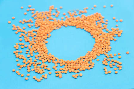 red lentils pile or masoor dhal isolated on blue background,の写真素材