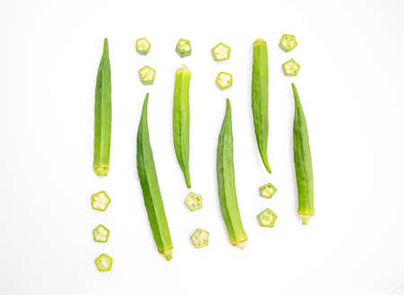 whole okra and slices Lady Finger design over on white backgroundの写真素材