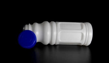 selective focus, white juice bottle isolate on black backgroundの写真素材