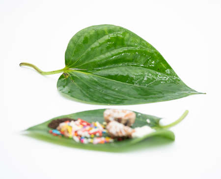 focus on betel leaf, with areca nut and Kapor Sireh isolate on white backgroundの写真素材