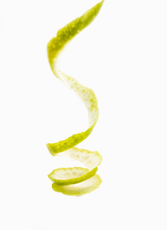 twist peel on a white background. Spiral of lemon skin.