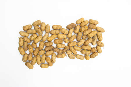 dry Unpeeled peanuts close up isolated on white background