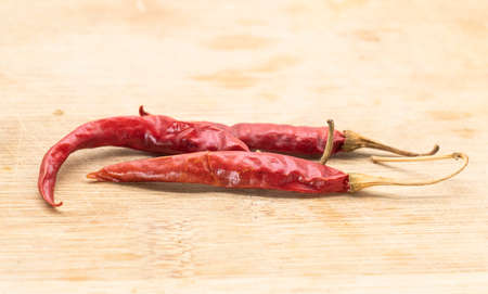 red chili isolated on wooden background,