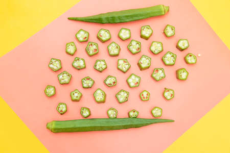 fresh okra slice isolated on colorful background, top view