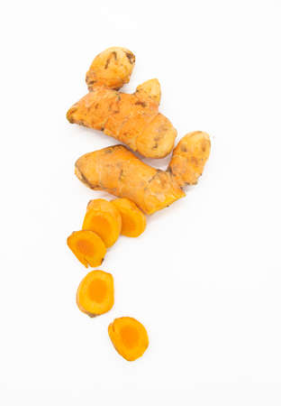 Raw turmeric and turmeric powder flat on white