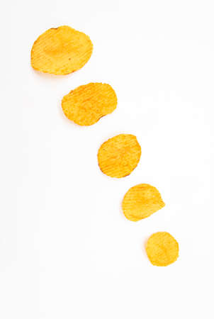 potato crisps on white background, top view,selective focus
