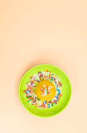 yellow laddoo with decoration isolate on colorful background, top viewの写真素材
