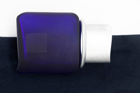 Bottle of perfume on white and blue background,top viewの写真素材